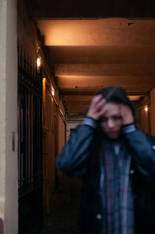 a person is walking down a narrow hallway