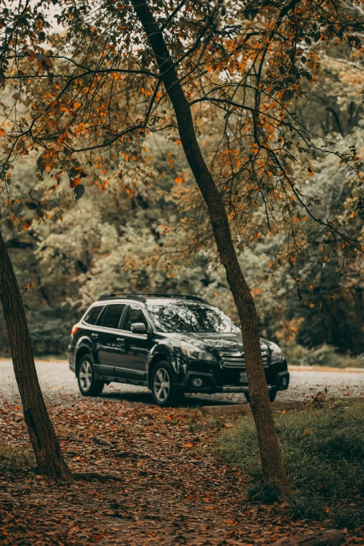 a black car sitting in the middle of the road