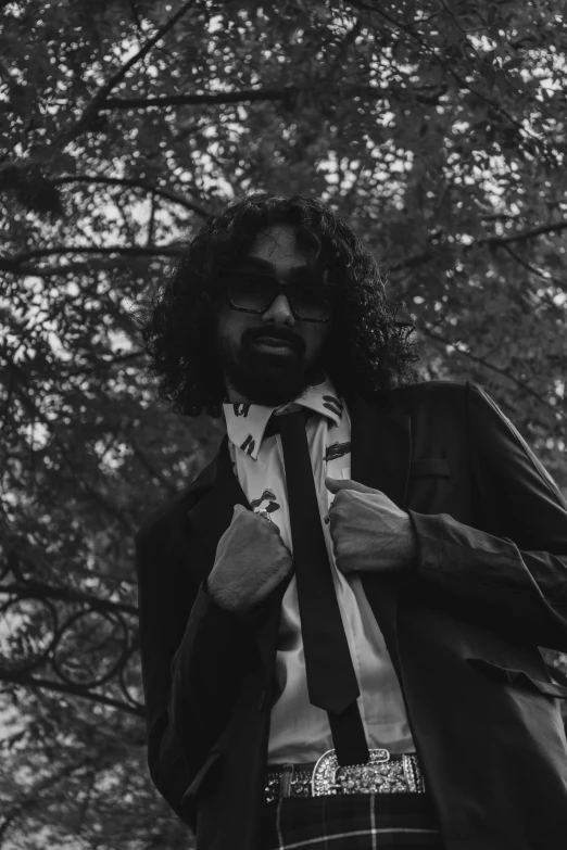 a man with long hair and a beard is standing outside