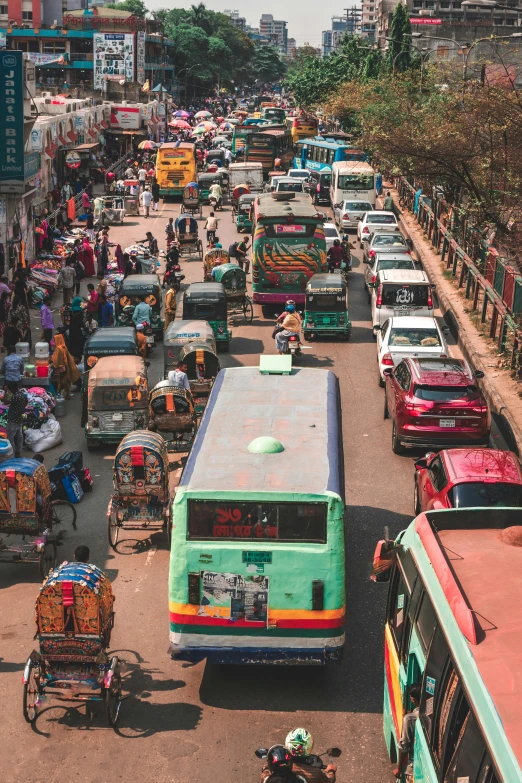 a city street with a number of buses and people sitting in the back