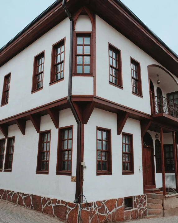 an interesting looking house with two brown windows