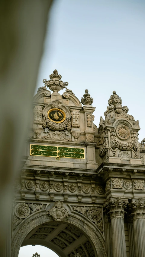 an archway with intricate carved designs and clock