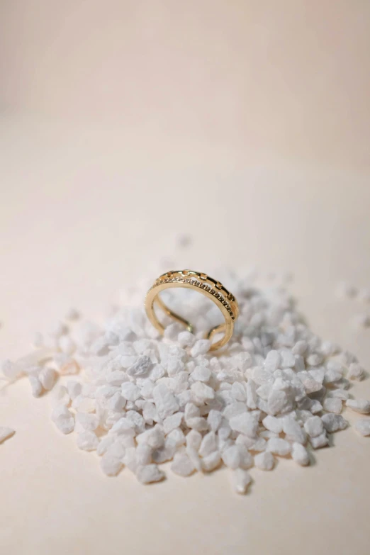 a ring sits on top of a pile of sea salt