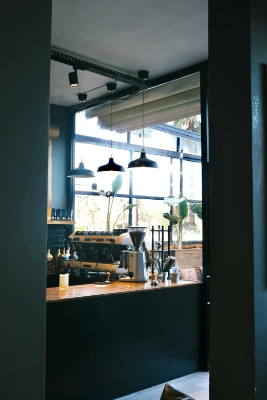 a kitchen with some lights hanging over the counter