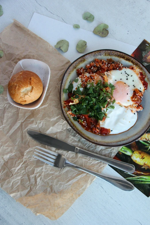 food including eggs on a plate and some bread are placed next to the poster of a chef