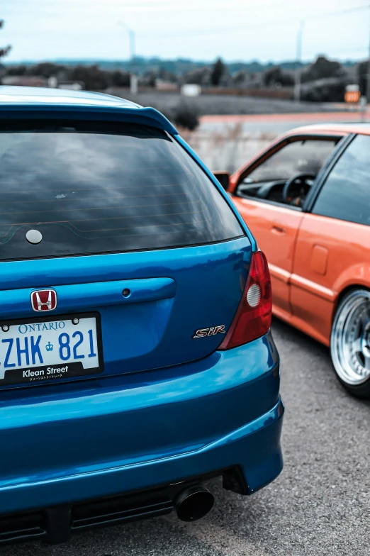 two cars parked next to each other in a parking lot