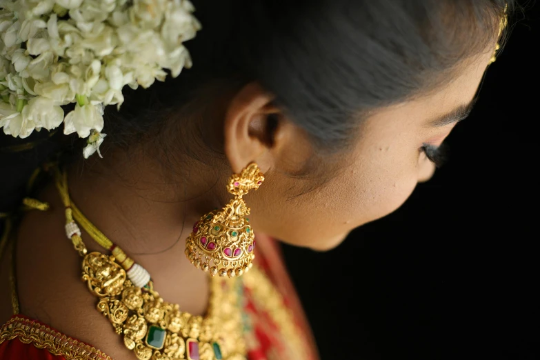 woman in red and gold jewelry and flowers