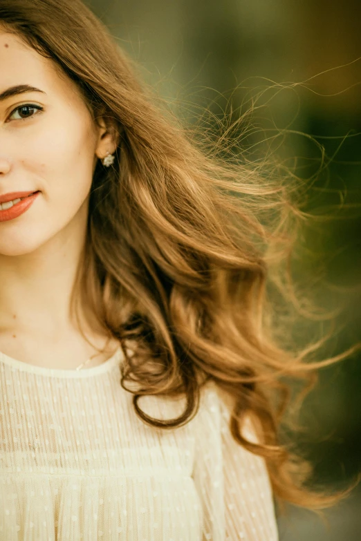 a woman smiles while wearing a dress