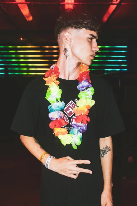 the young man is wearing colorful hawaiian leis