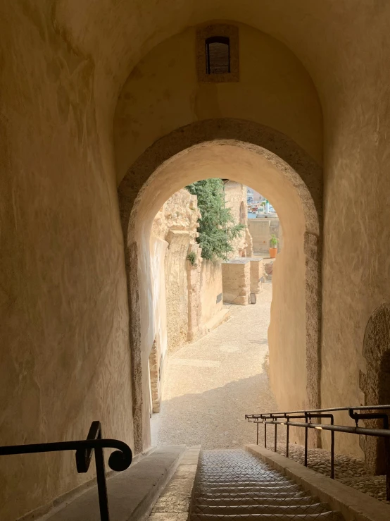 an alley way that has steps leading up to a stairwell