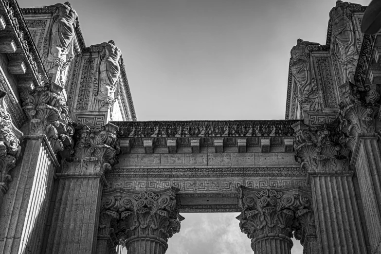 the arches of an ornate building in black and white