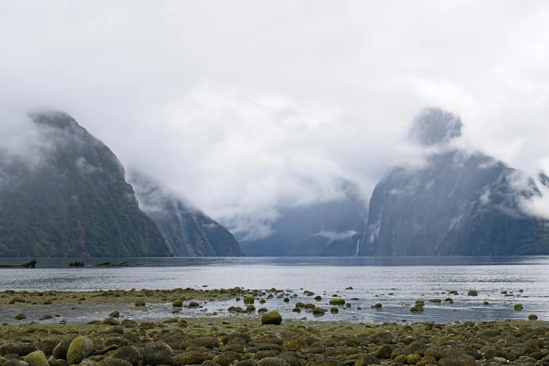 a beautiful landscape with a body of water and mountains in the distance