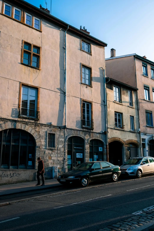 a city street that is lined with several large old buildings