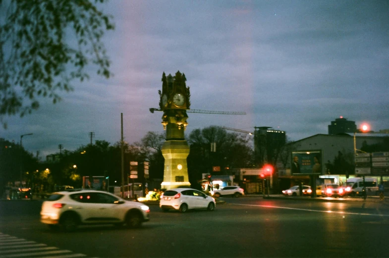 a tower stands over the intersection in a city at night