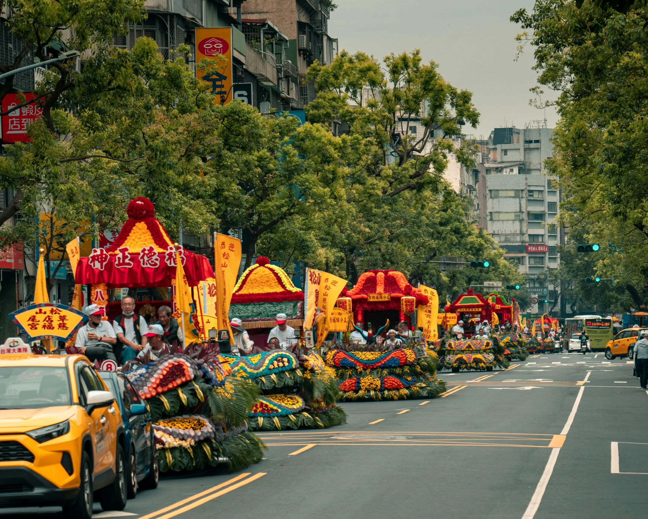 many floats and dragon heads are parade floats in a parade