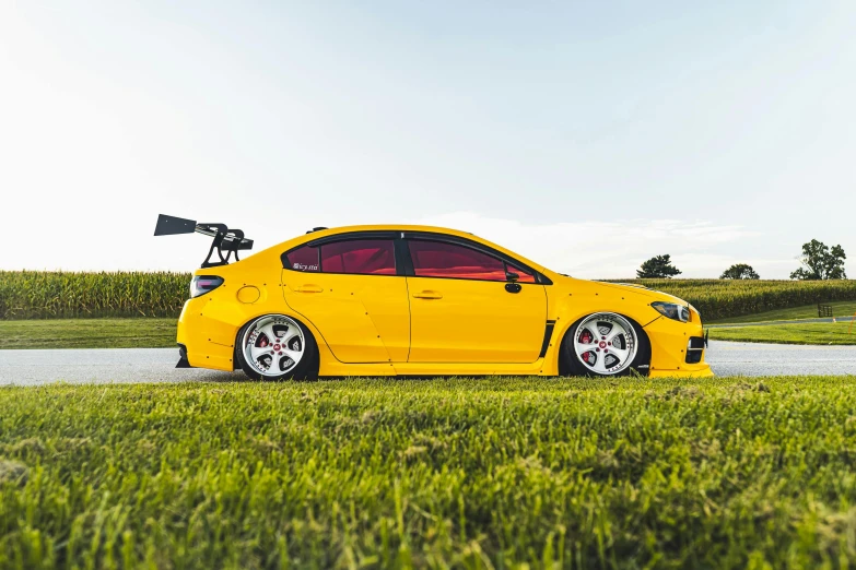 a yellow sports car parked near a road