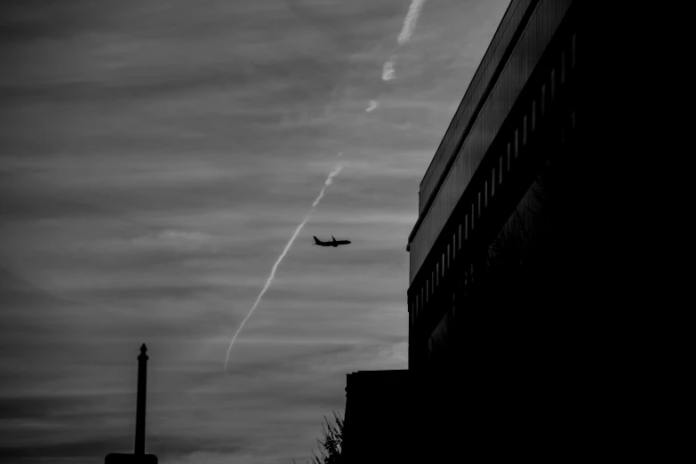 an airplane leaving on a track and leaving its contrails in the sky