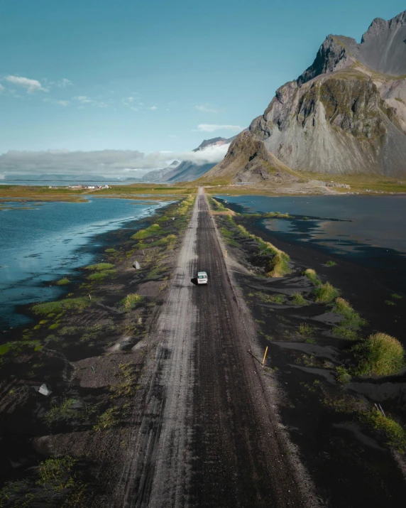 the truck is parked in front of the large mountains