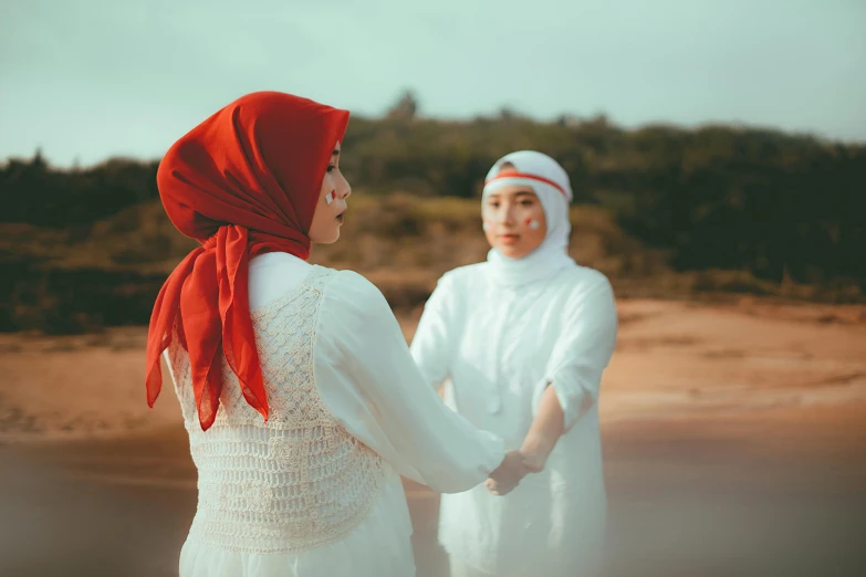 two people holding hands as they walk through the desert