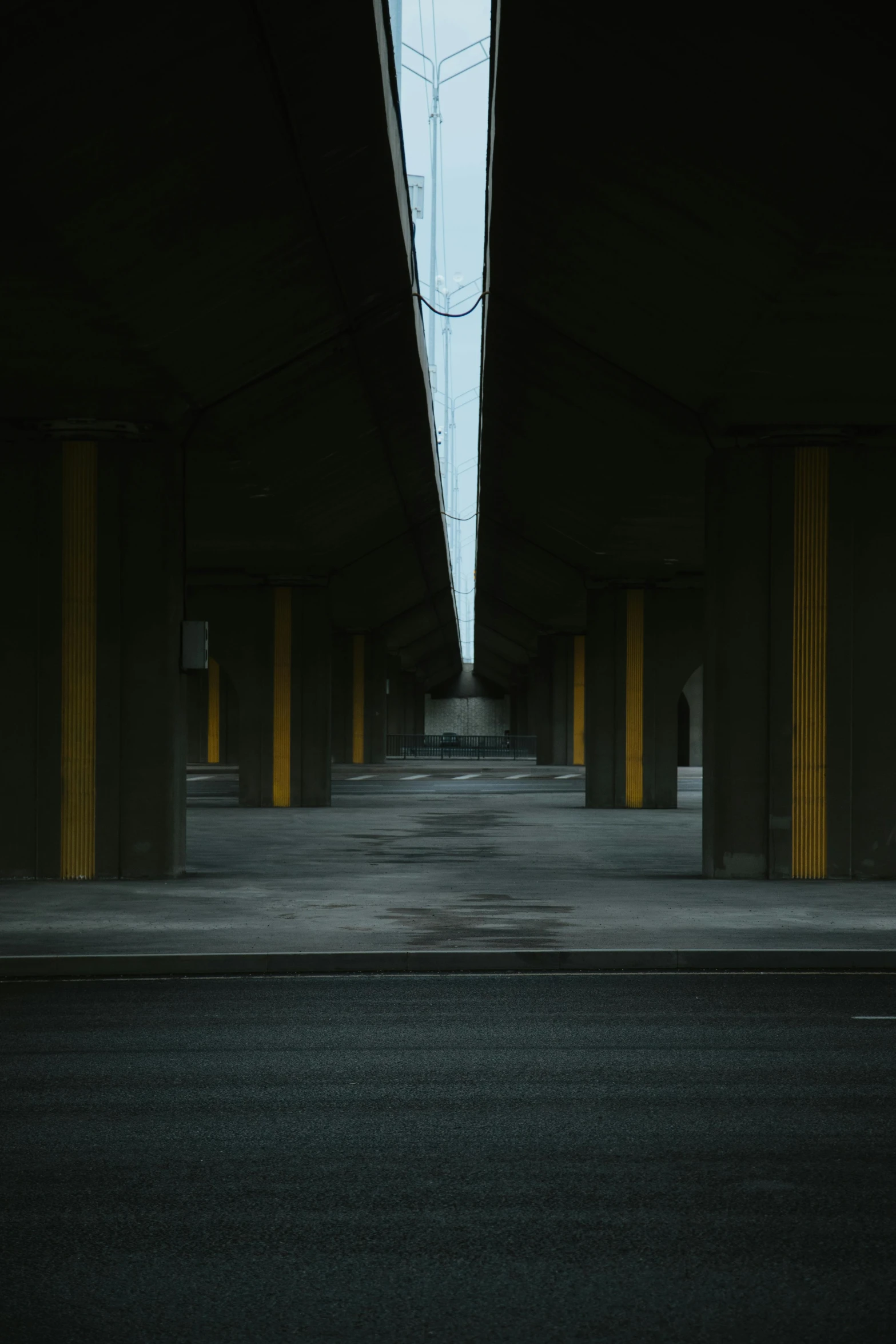 an empty street under an overpass and very long