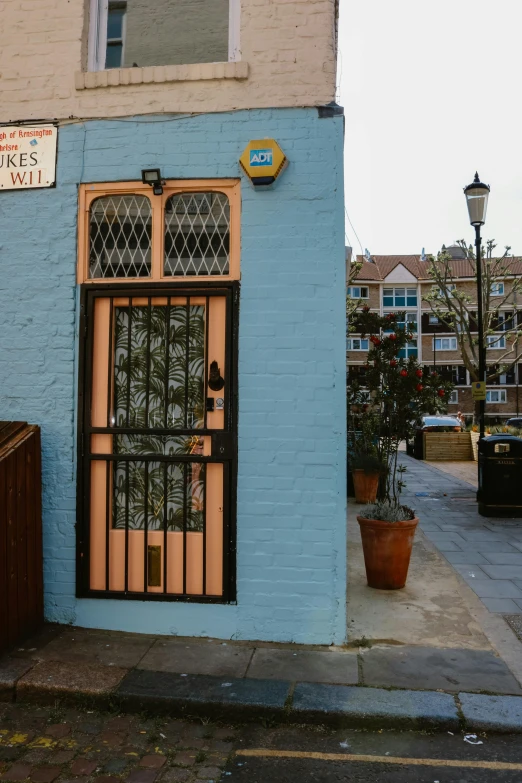 a blue building with windows, a door, and a sign