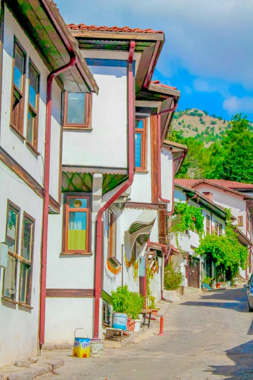 this is a street with white buildings and brown trim