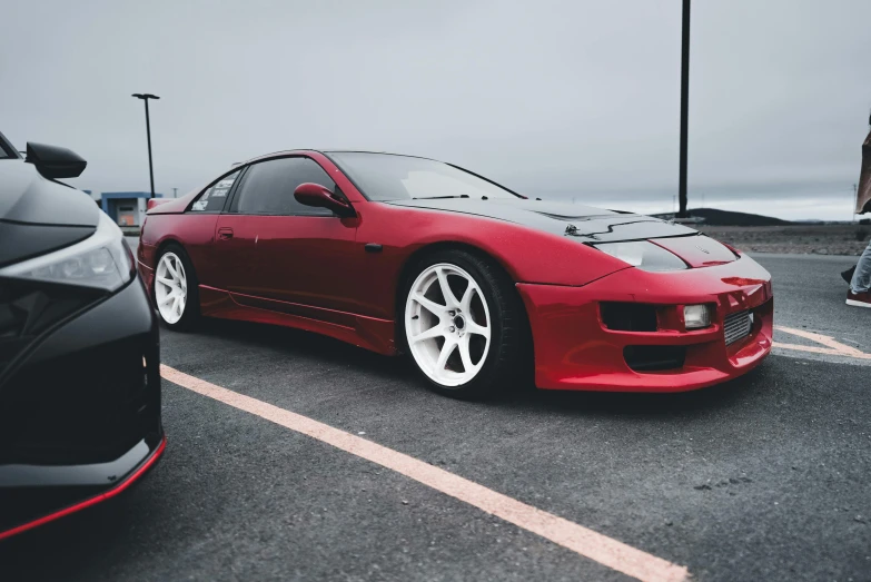 a red sports car parked in a parking lot