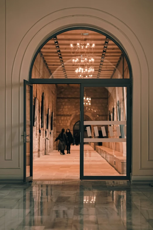 a pair of people standing in front of an ornate doorway