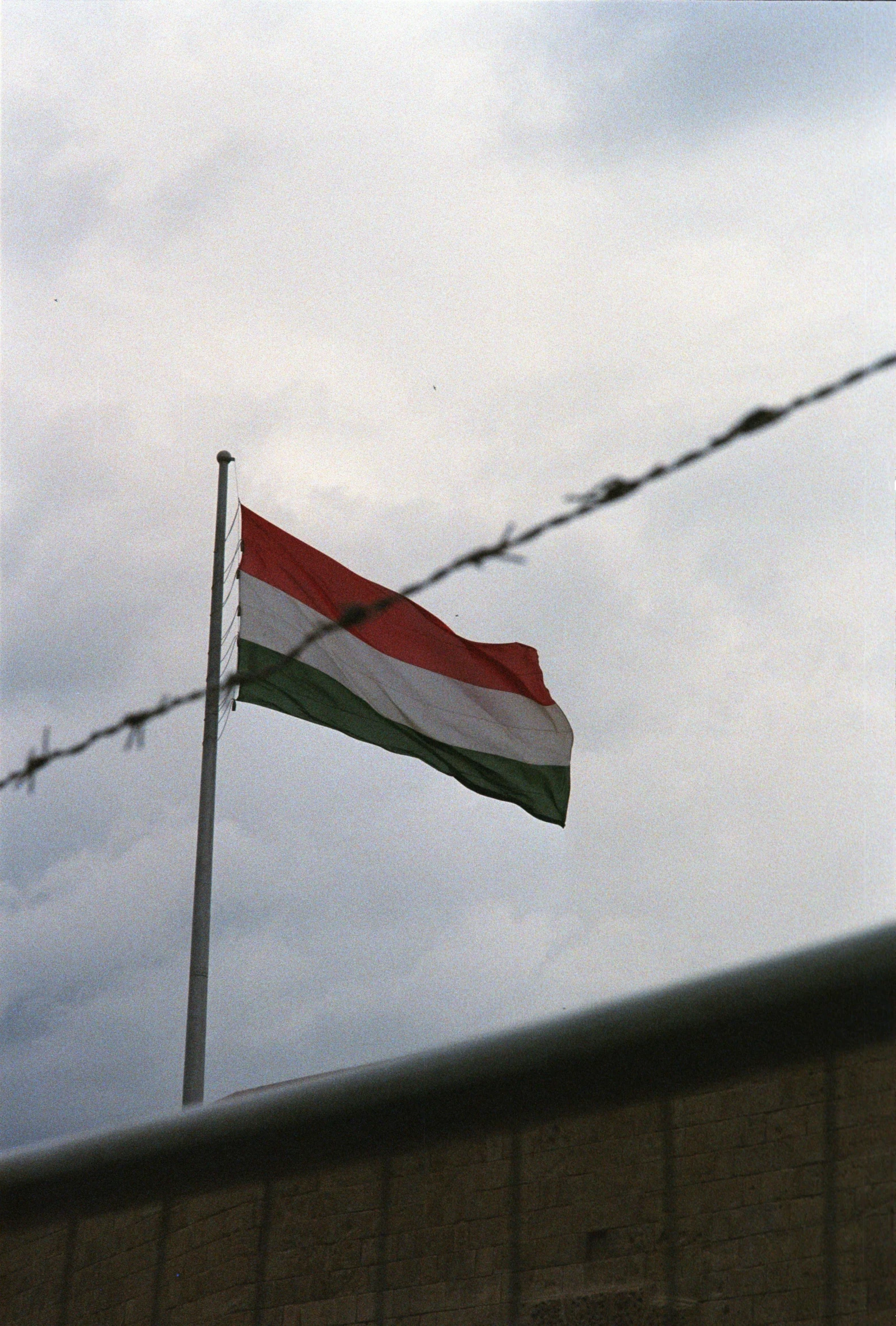 a flag flying from the side of a building