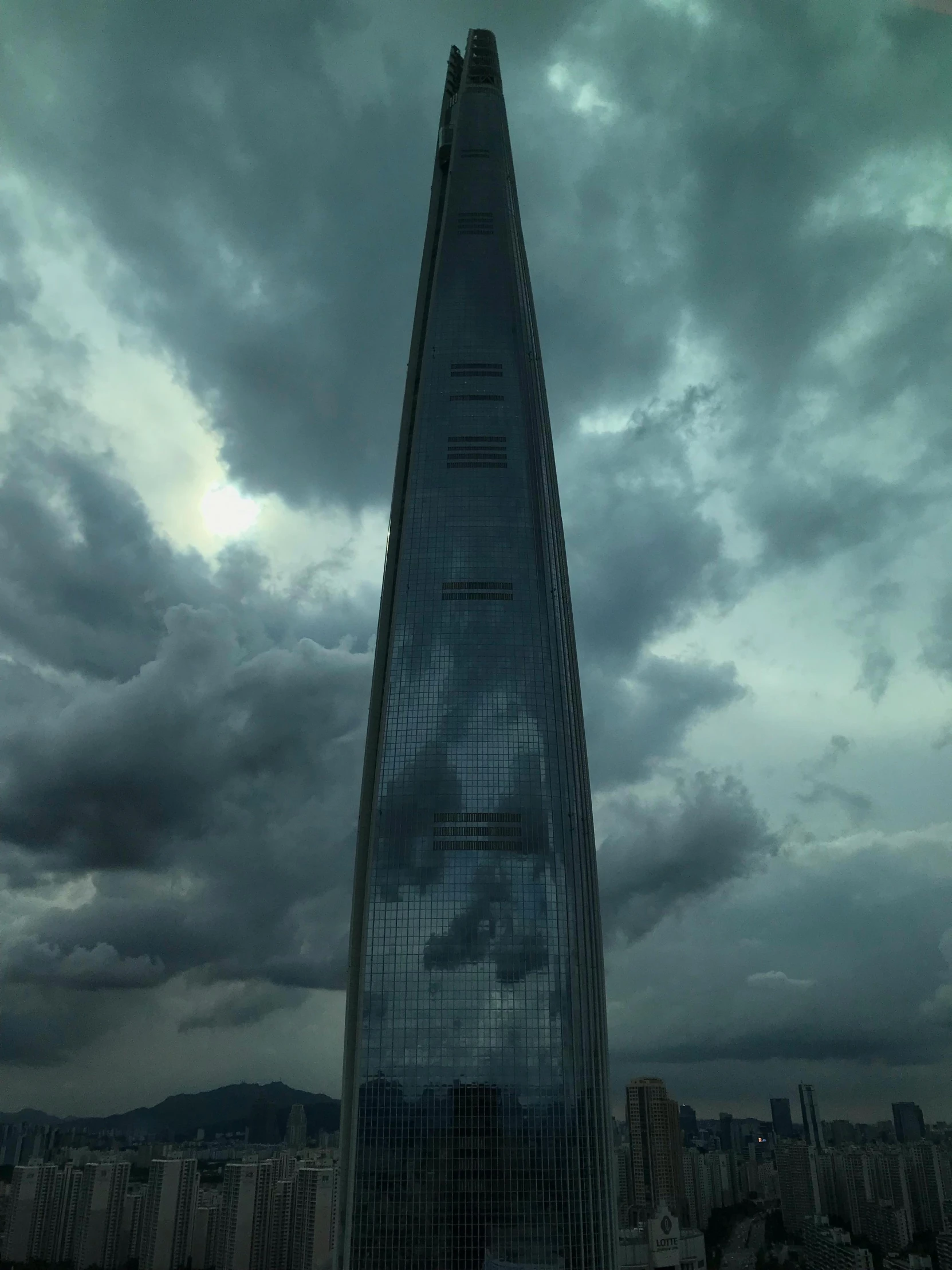 a tall building is standing alone near a cloudy sky