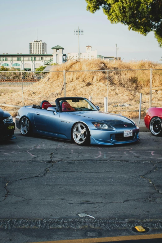 three cars are sitting in a parking lot near the road