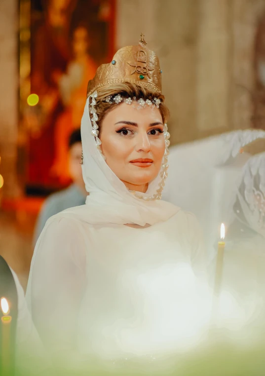 a woman with a gold crown and white dress