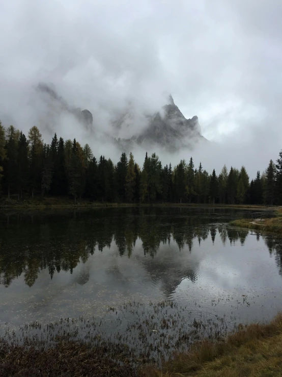 a po of a mountain peak with clouds and water