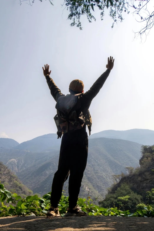 the person has his arms in the air above his head