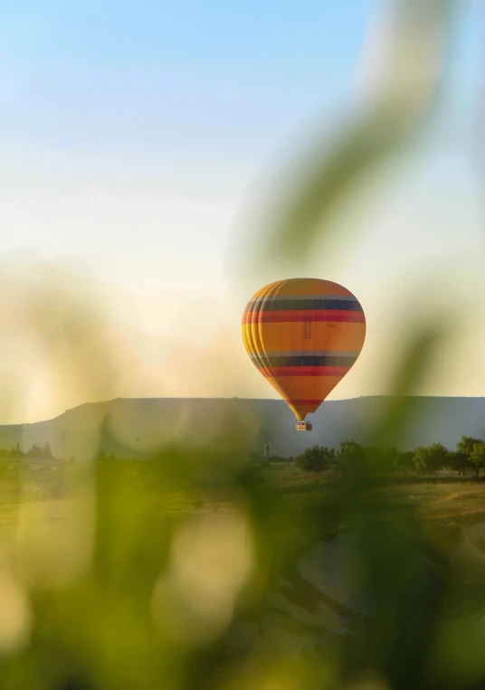 two  air balloons in the sky above a field