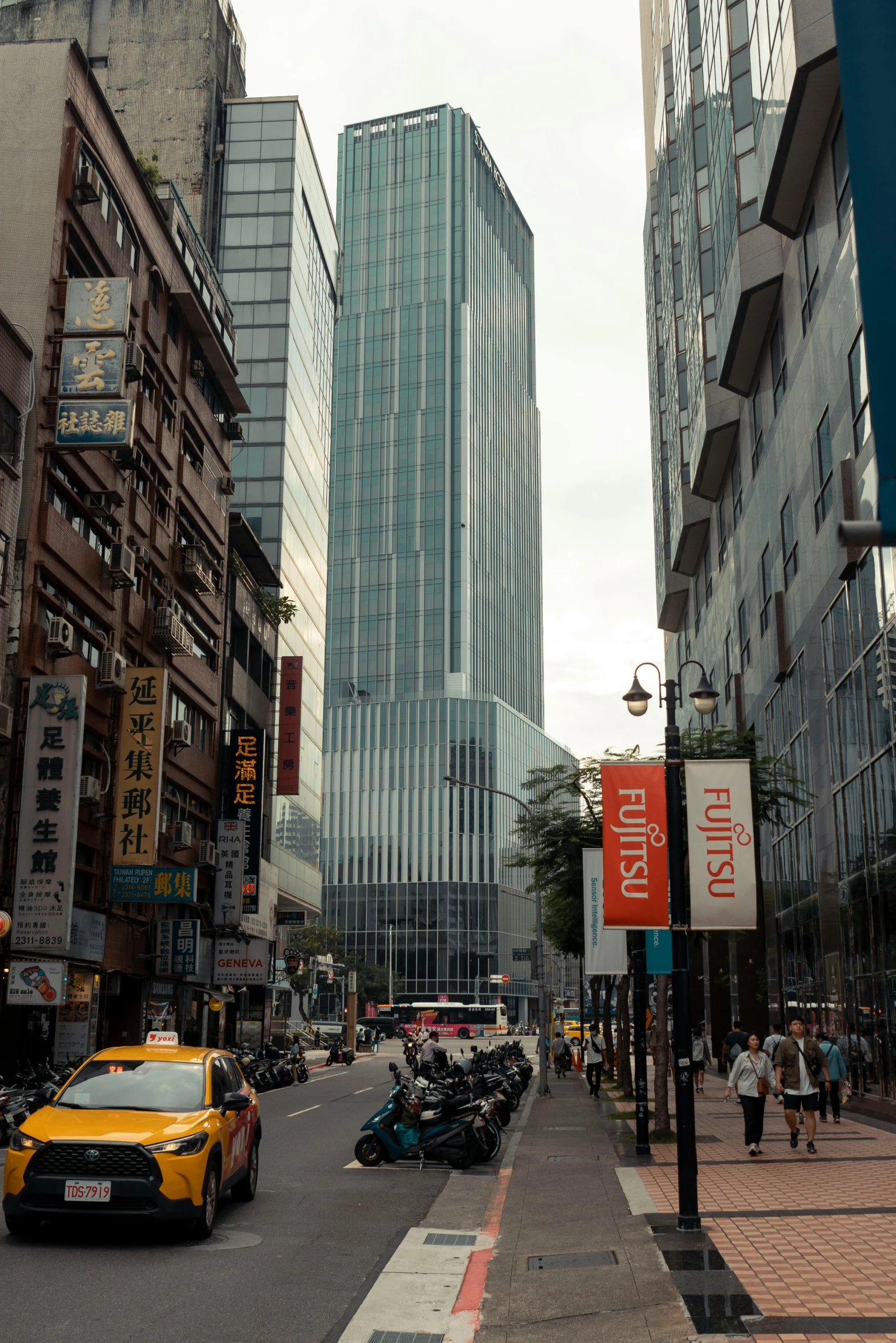 a city street with tall skyscrs in the background