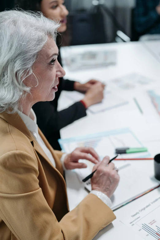 two women sit at a table and discuss a problem