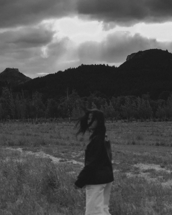 woman flying a kite on a windy day