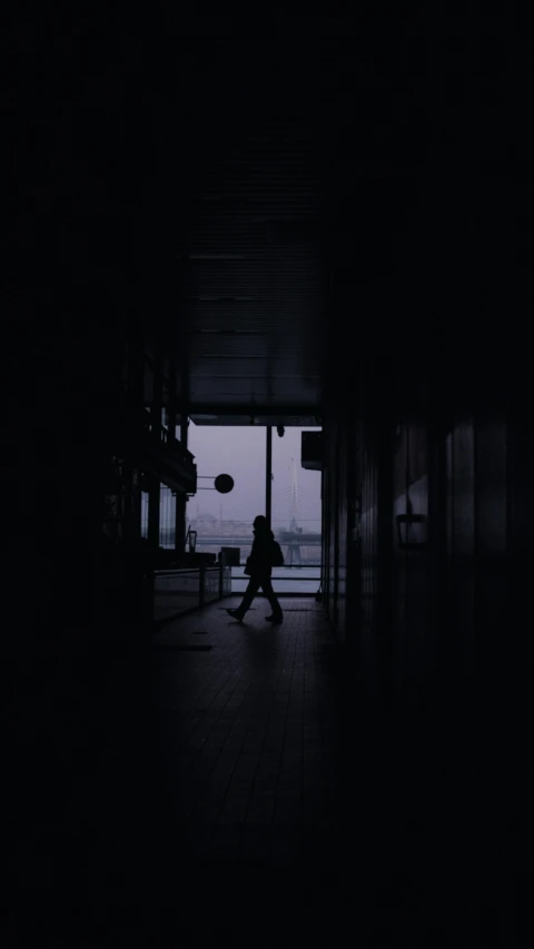 a person walking into an open doorway at night