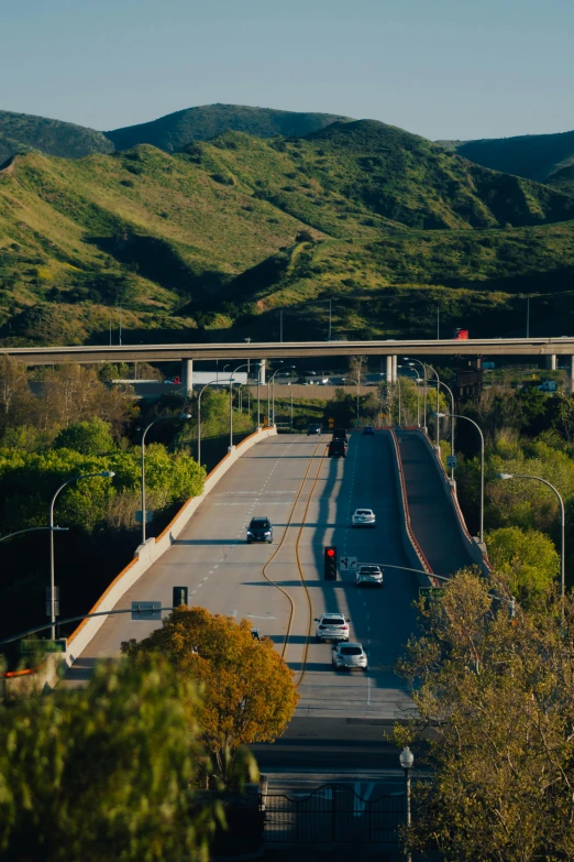 an intersection with road and mountain view on the horizon