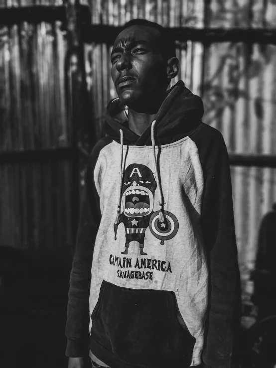 man wearing sweat jacket standing in black and white