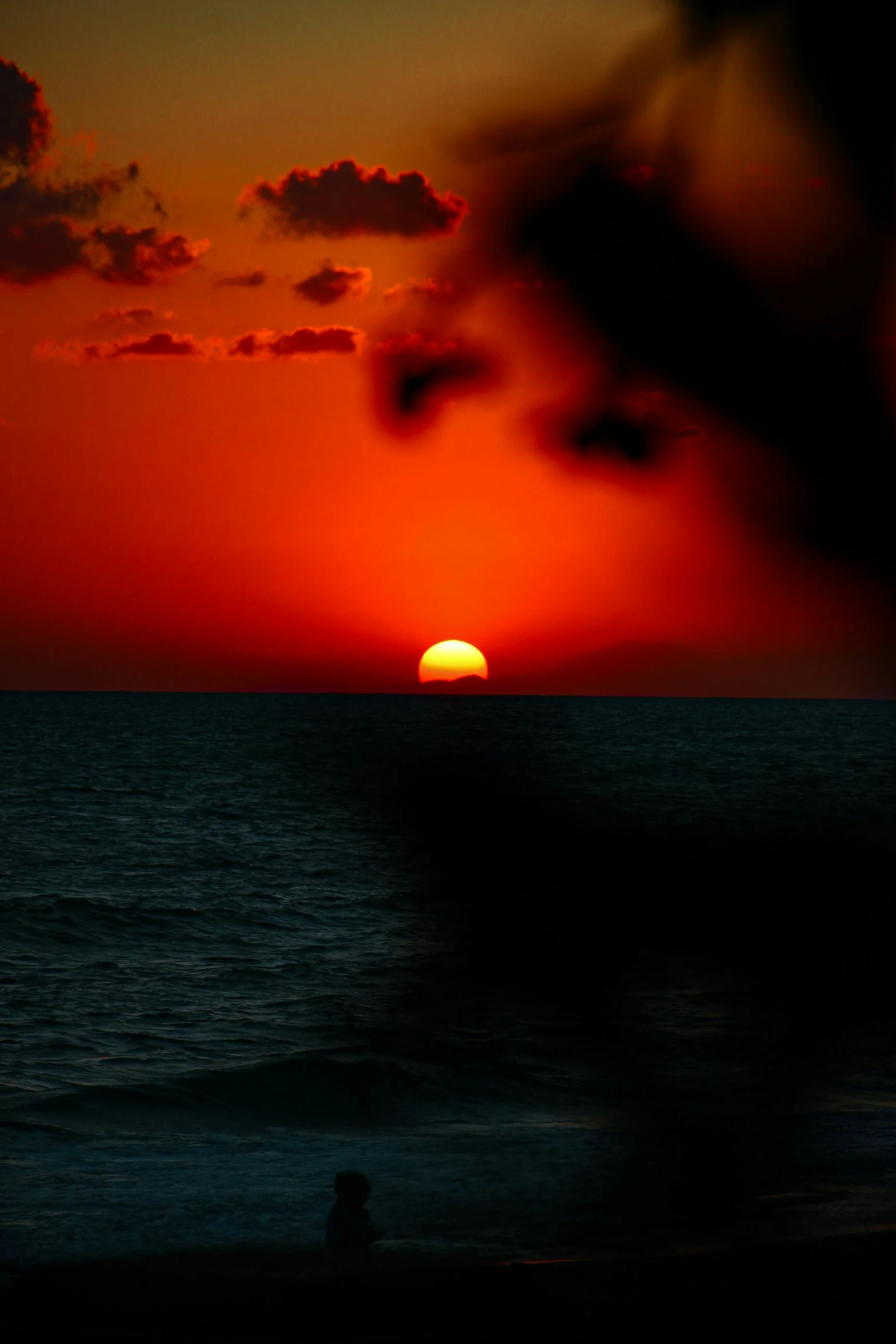 there is a person at the beach at sunset