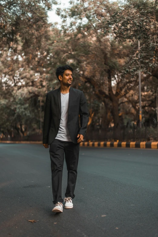 the man is standing on the street in the middle of the day