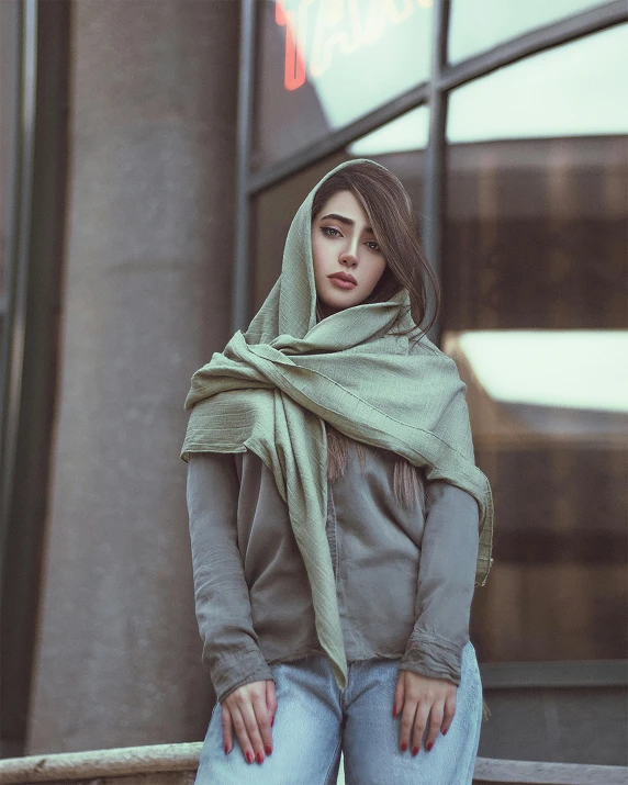 a woman wearing jeans and jacket standing outside