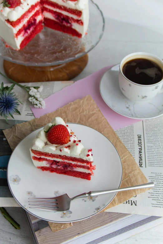 a cake with white frosting, strawberries on it