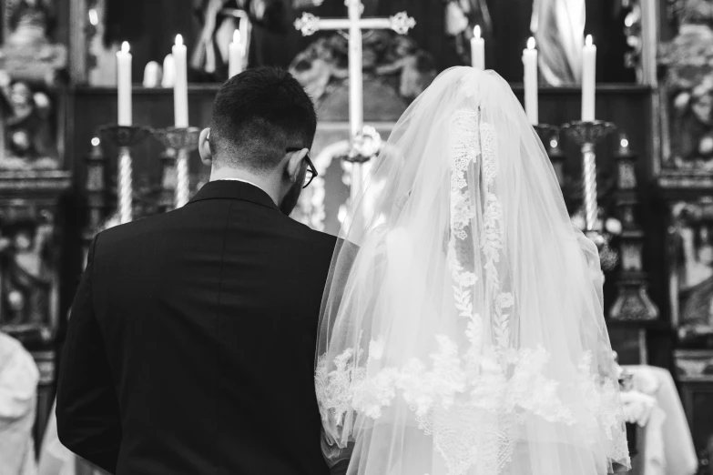 a man and woman standing in front of a church