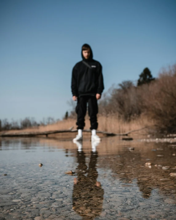 man standing on side of clear and shallow area