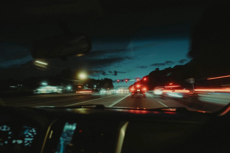 a night scene of a busy highway with many car lights