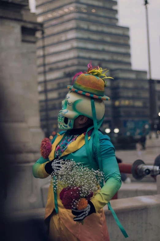 a person dressed as a skeleton holding a bunch of flowers