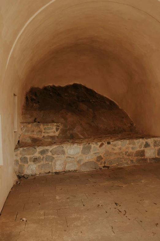 a stone oven with an overhang over it and a pizza laying on top